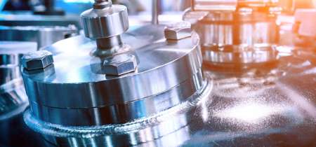 Close-up of a shiny stainless steel industrial machine component.