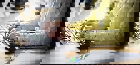 Person typing on keyboard